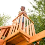 KidKraft Ridgemoor Perch Wood Swing Set with Playhouse, Rock Wall, and Tunnel Slide - Image 6