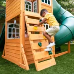 KidKraft Ridgemoor Perch Wood Swing Set with Playhouse, Rock Wall, and Tunnel Slide - Image 7