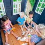 KidKraft Cozy Escape Navy Two-Story Wood Playhouse with Tube Slide and Clubhouse - Image 6